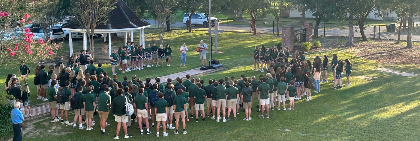 Students praying at the front entrance of the campus