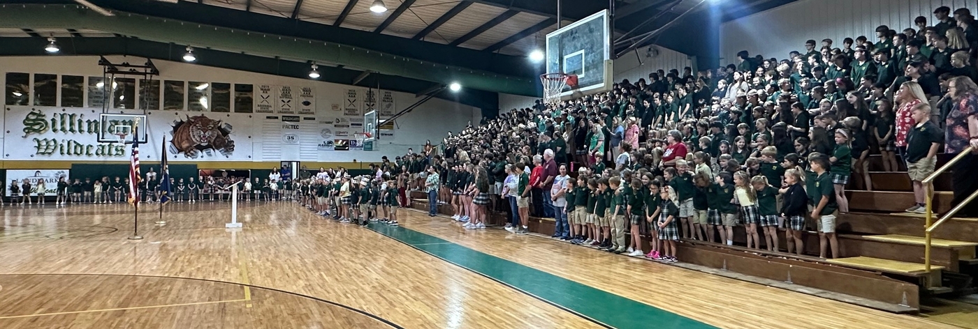 Image of students in the gymnasium at a school event.