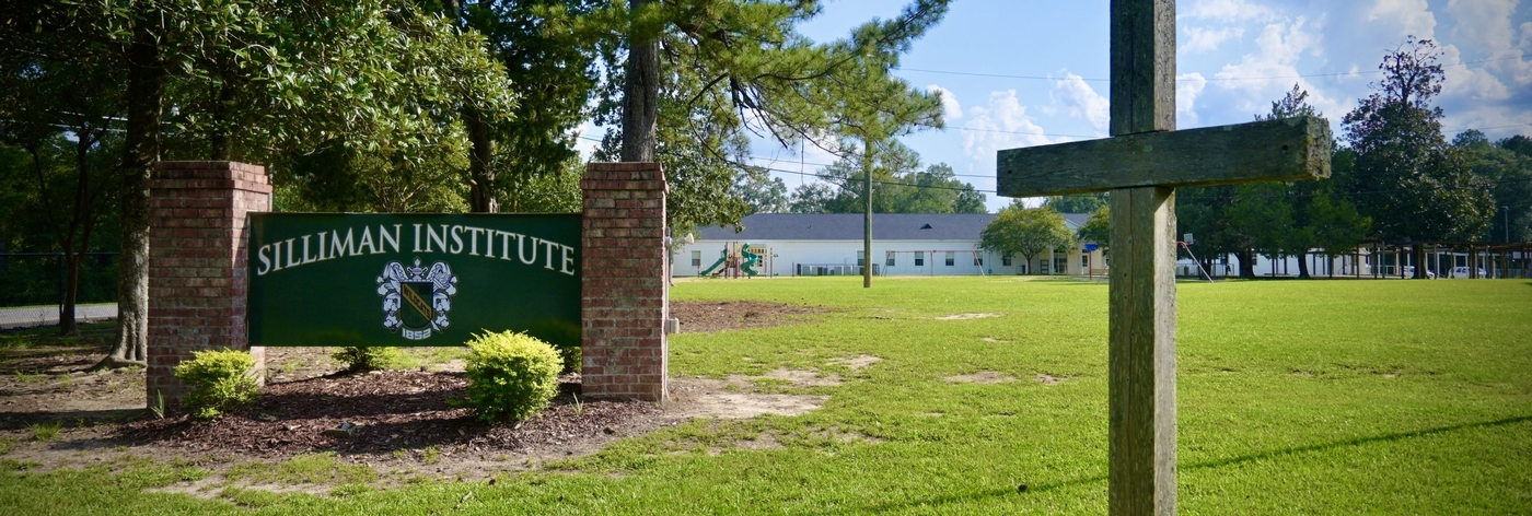 Image of Silliman's exterior sign with a cross to side of the sign