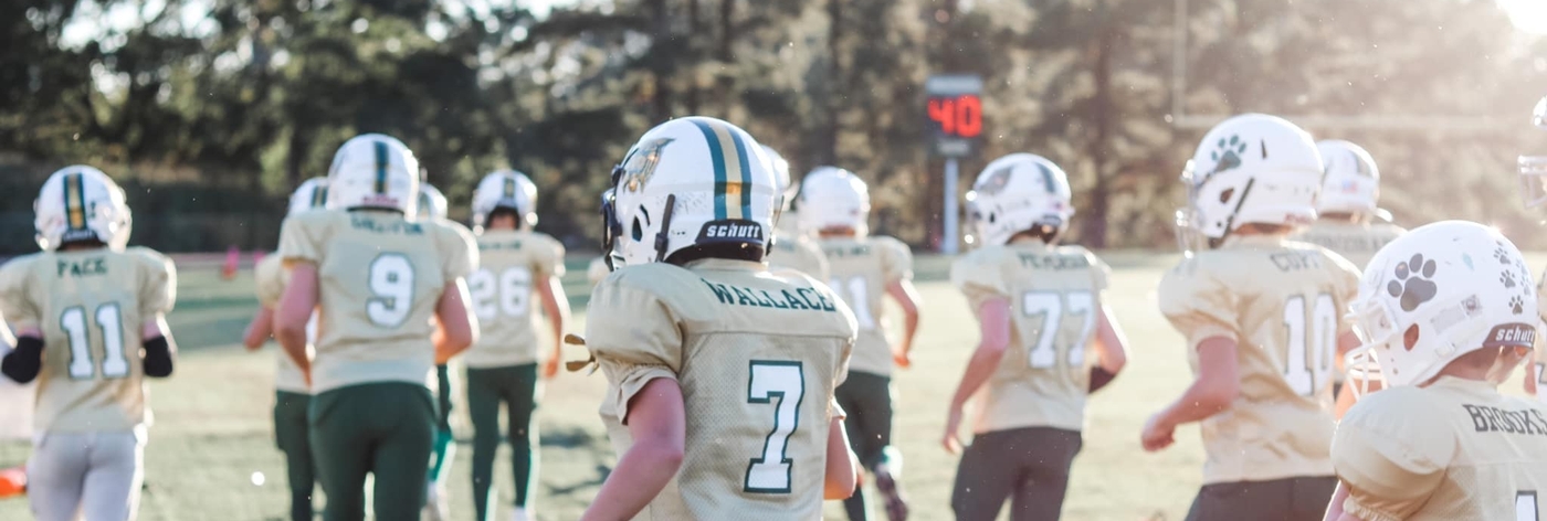 Image of Junior Wildcat Football players running on the field