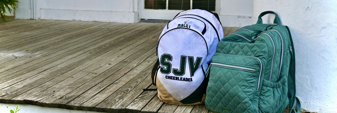 Image of backpacks on the front porch