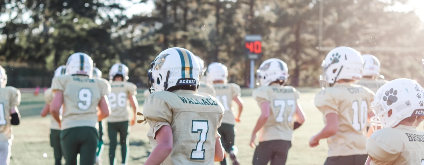 Image of Junior Wildcat Football Players on the field running