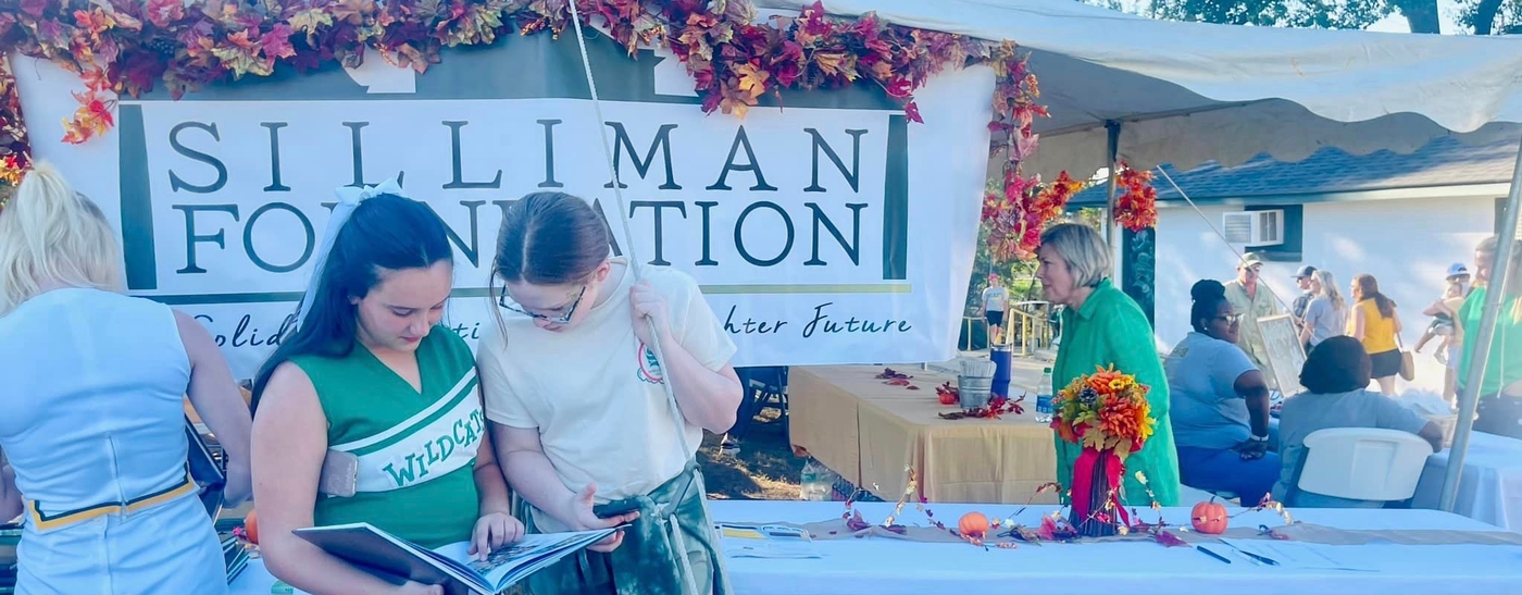 Image of people under a tent at a Silliman Foundation event.